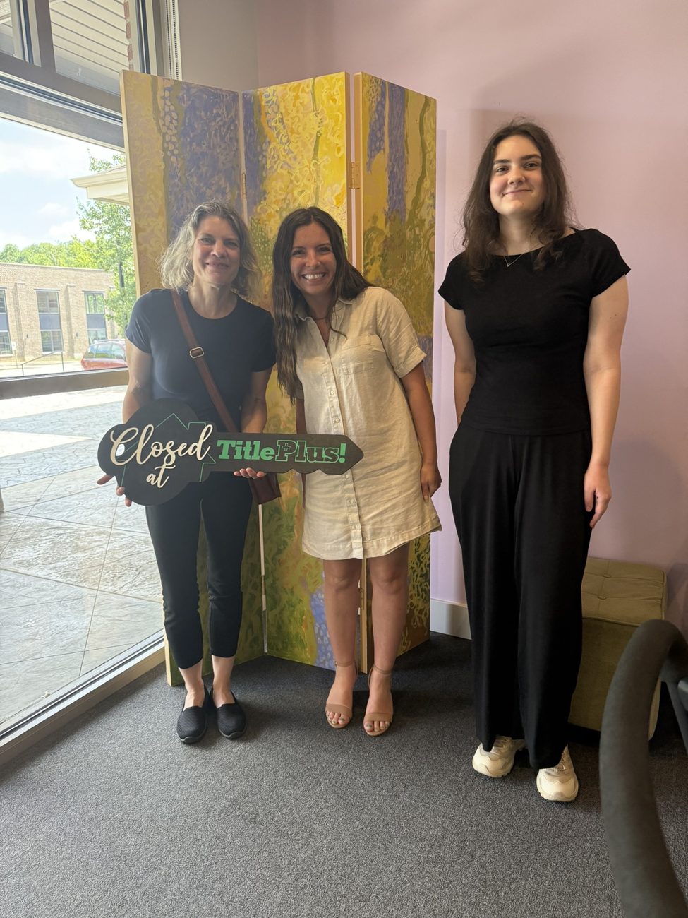 Lavinia Chudy celebrating a closing day with clients holding a TitlePlus key