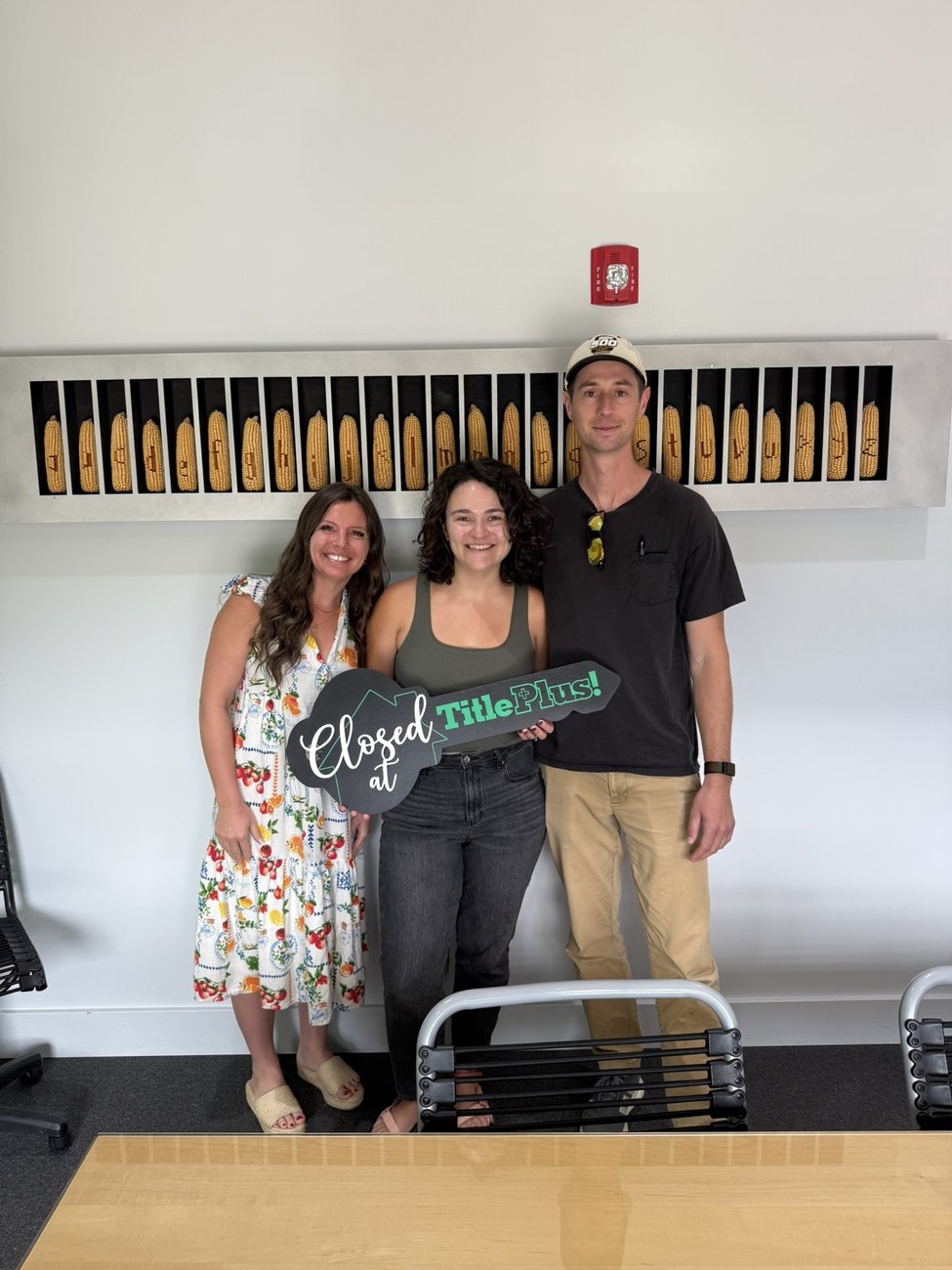 Lavinia Chudy celebrating a closing with clients in Bloomington, IN